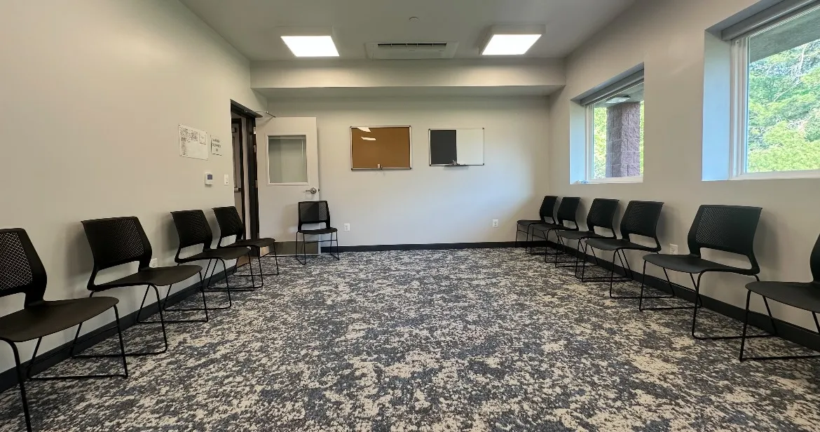 Group therapy room with chairs set around the walls at Still Detox New Jersey