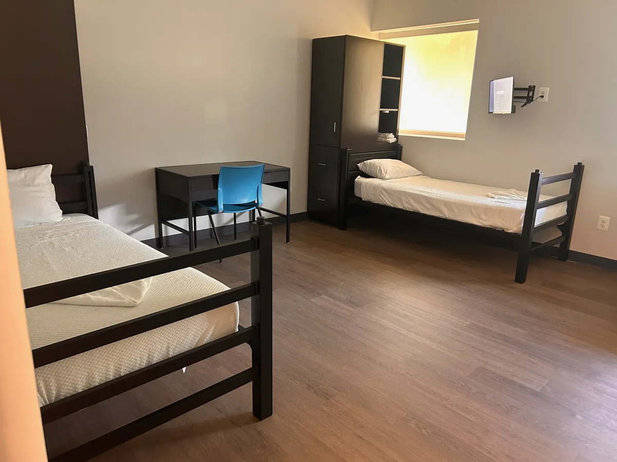 Shared client bedroom with two beds and a desk at Still Detox New Jersey